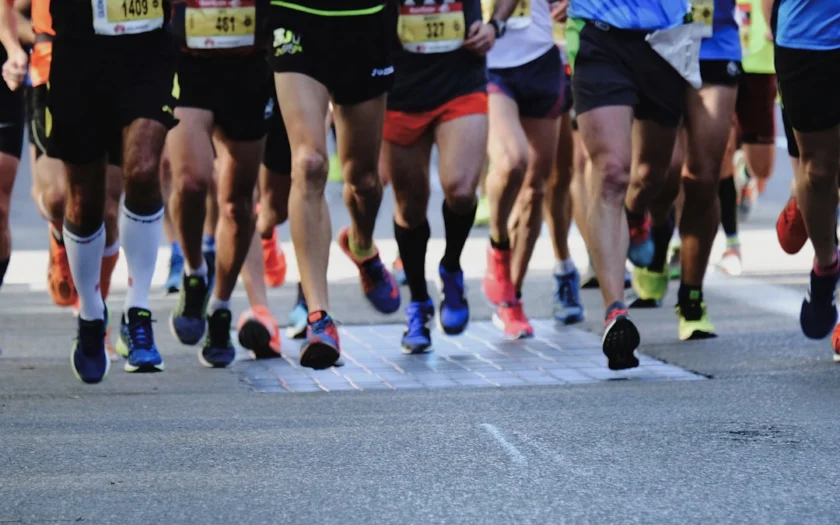 people running on gray asphalt road during daytime